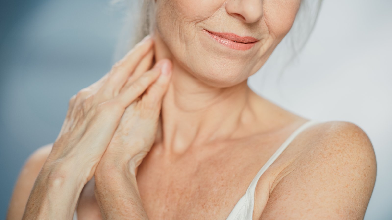 Close up of mature woman’s neck and lower face showing smooth skin and natural texture after anti-wrinkle treatment