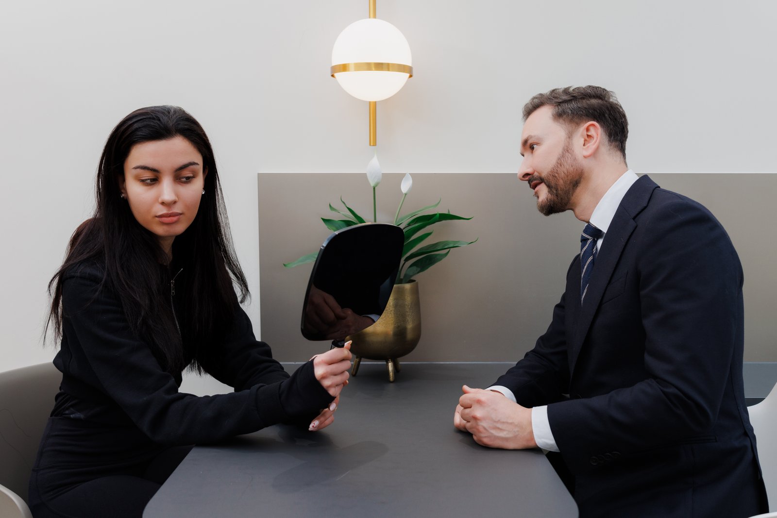 UltraClear laser consultation London patient examining skin with mirror during treatment assessment